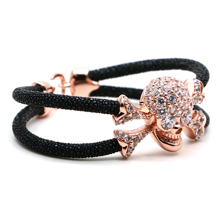 edgy twist elegance bracelet features skull crossbones covered precious stone two hand-wrapped stingray leather cords bracelet