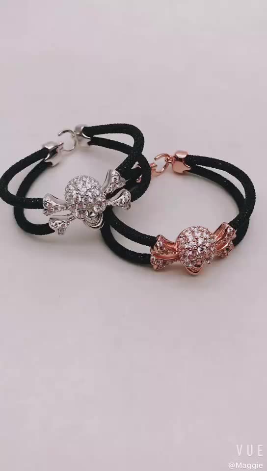 edgy twist elegance bracelet features skull crossbones covered precious stone two hand-wrapped stingray leather cords bracelet